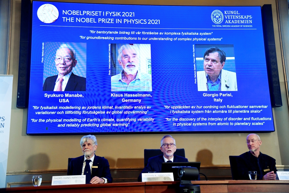 Member of the Nobel Committee for Physics Thors Hans Hansson, Secretary General of the Royal Swedish Academy of Sciences Goran K. Hansson, and member of the Nobel Committee for Physics John Wettlaufer announce the winners of the 2021 Nobel Prize in Physic