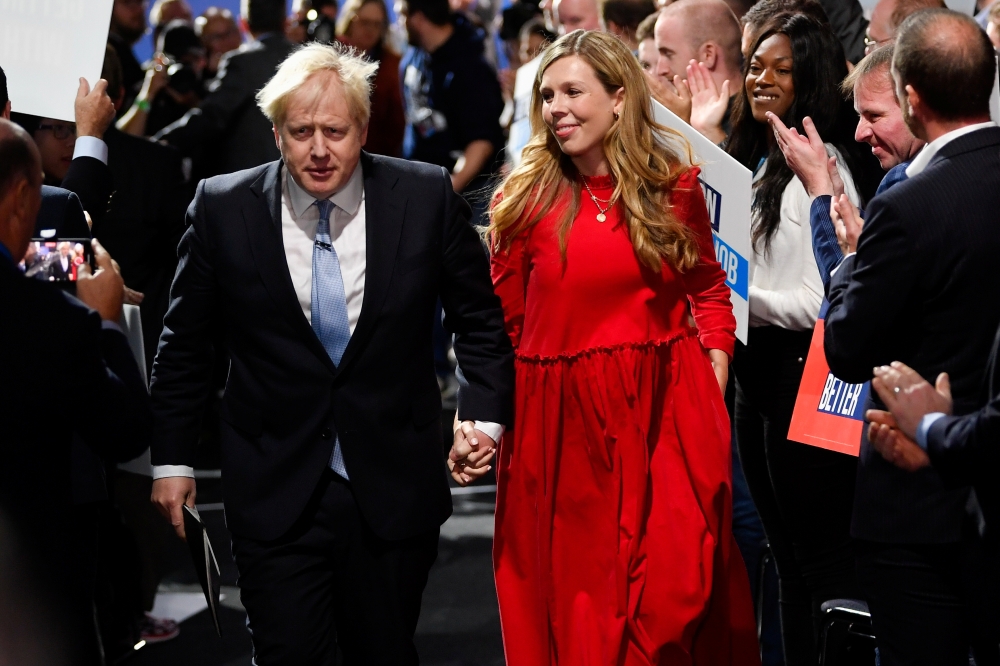 Britain's Prime Minister Boris Johnson departs with his wife Carrie Johnson after delivering a speech during the annual Conservative Party Conference, in Manchester, Britain, October 6, 2021. Reuters/Toby Melville