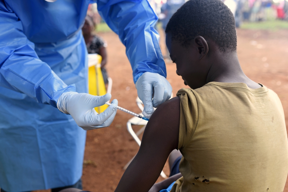 FILE PHOTO: A Congolese health worker administers Ebola vaccine to a boy who had contact with an Ebola sufferer in the village of Mangina in North Kivu province of the Democratic Republic of Congo, August 18, 2018. REUTERS/Olivia Acland