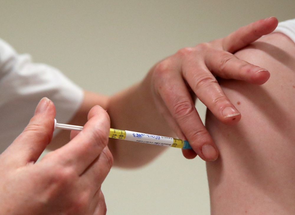 A volunteer receives a dose of CureVac vaccine or a placebo during a study by the German biotech firm CureVac as part of a testing for a new vaccine against the coronavirus disease (COVID-19), in Brussels, Belgium March 2, 2021. REUTERS/Yves Herman/File P