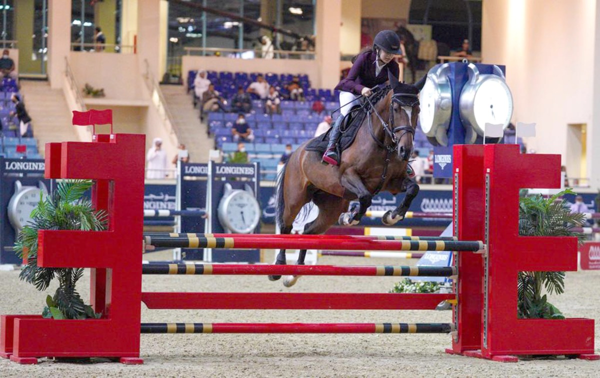 Haya Khalid Al Hitmi guides Dusty over a hurdle during yesterday's Small Tour competition.