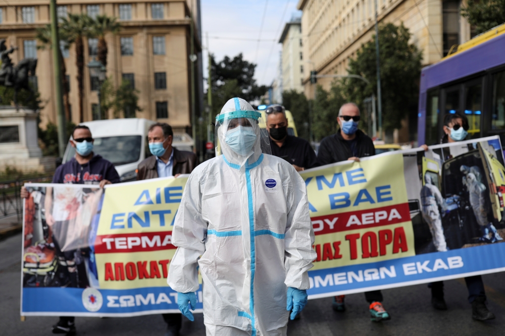 A health worker wearing personal protective equipment walks during a health sector workers' protest as Greek hospitals are under pressure due to escalating coronavirus disease (COVID-19) cases, in Athens, Greece, November 15, 2021. REUTERS/Louiza Vradi TPX IMAGES OF THE DAY
