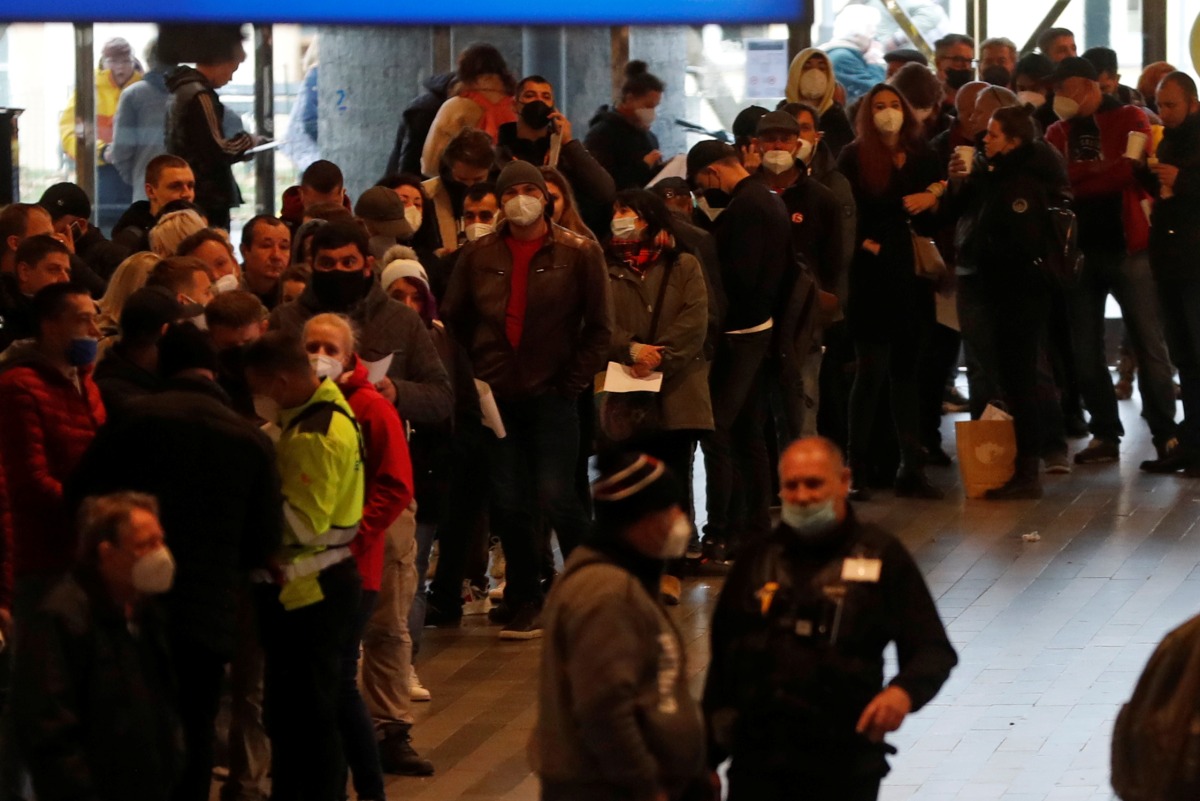 People wait in a line to get the coronavirus disease (COVID-19) vaccine at Prague's main railway station, Czech Republic, November 22, 2021. REUTERS/David W Cerny
