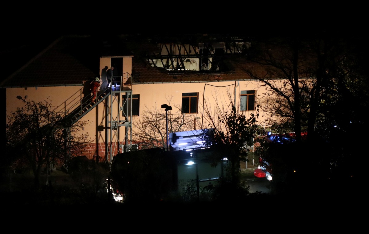 Firefighters enter a nursing home where nine people were killed in a fire in the village of Royak, Bulgaria, November 22, 2021. Lyubomir Benkovski/Bulphoto Agency/via REUTERS
