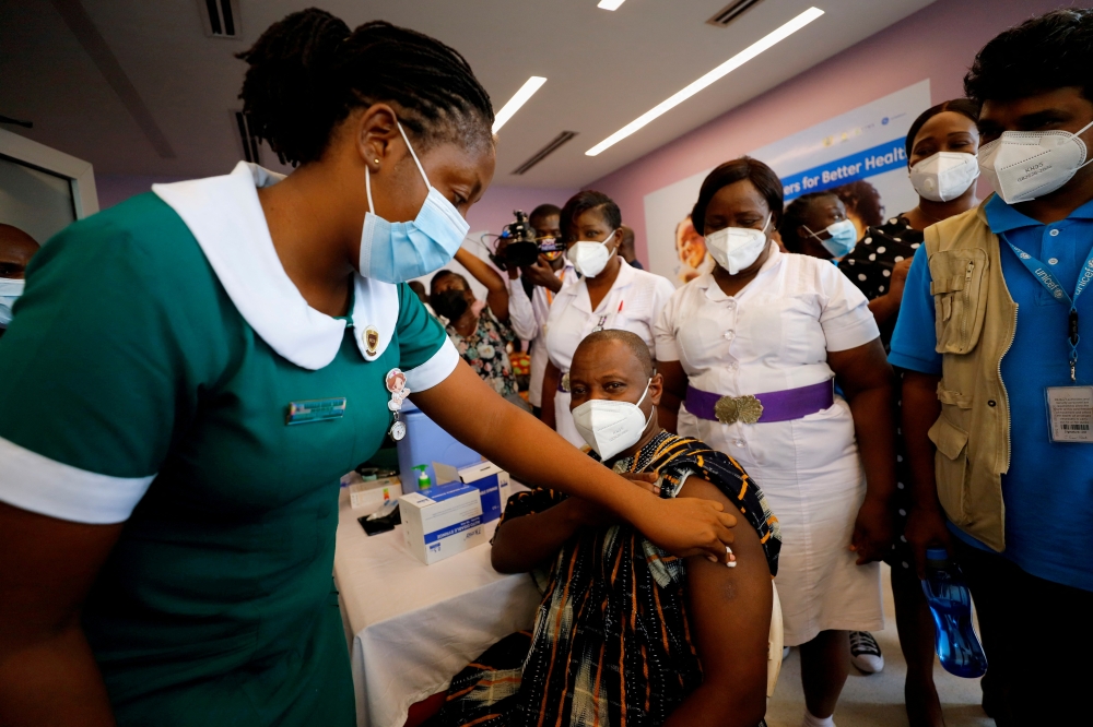 Director General of the Ghana Health Service Dr. Patrick Kuma-Aboagye receives the coronavirus disease (COVID-19) vaccine during the vaccination campaign at the Ridge Hospital in Accra, Ghana March 2, 2021. REUTERS/Francis Kokoroko/File Photo