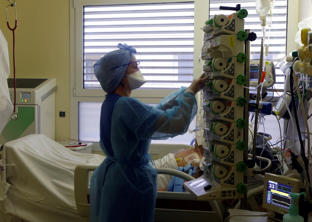 A medical staff member works in the Intensive Care Unit (ICU) for COVID-19 patients at La Timone hospital in Marseille, as France is seeing an increase in coronavirus disease (COVID-19) cases and hospitalisations, France, December 10, 2021. REUTERS/Eric Gaillard