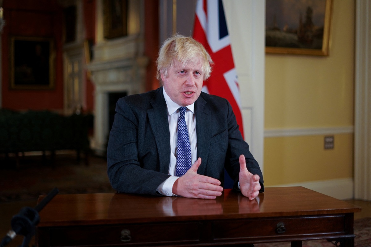 British Prime Minister Boris Johnson gestures as he records an address to the nation, to provide an update on the booster vaccine COVID-19 programme at Downing Street, London, Britain December 12, 2021. Kirsty O'Connor/Pool via REUTERS
