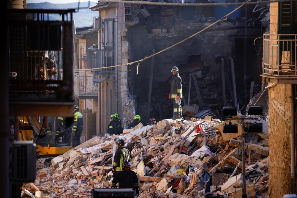 Rescuers work at the site of a gas explosion that caused several houses to collapse in Ravanusa, Italy, December 13, 2021. REUTERS/Guglielmo Mangiapane
 