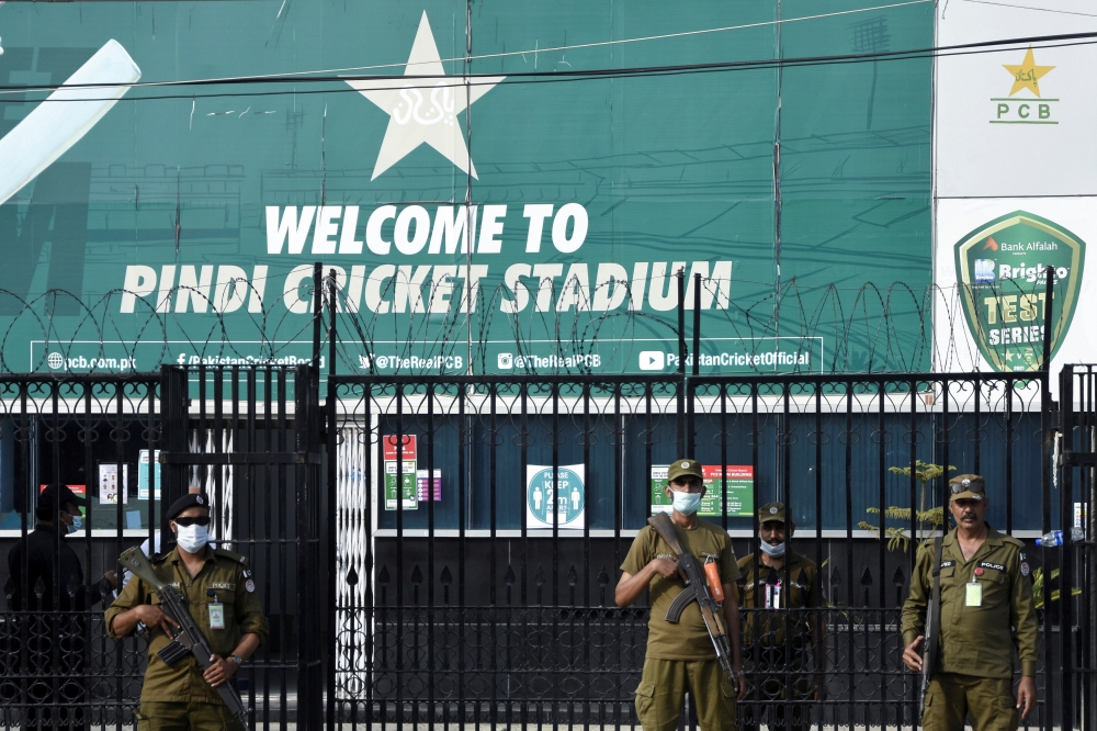 FILE PHOTO: Police officers stand guard outside Rawalpindi Cricket Stadium after New Zealand cricket team pull out of a Pakistan cricket tour over security concerns, in Rawalpindi, Pakistan September 17, 2021. REUTERS/Waseem Khan

