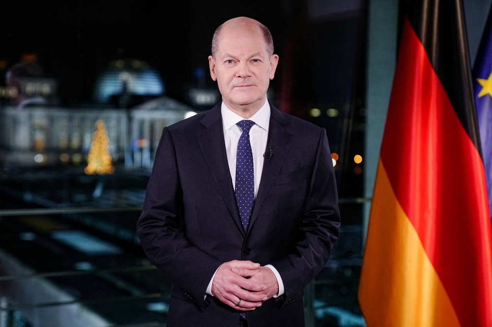 German Chancellor Olaf Scholz poses for photographs during the television recording of his annual New Year's speech at the chancellery in Berlin, Germany December 30, 2021. Kay Nietfeld/Pool via REUTERS