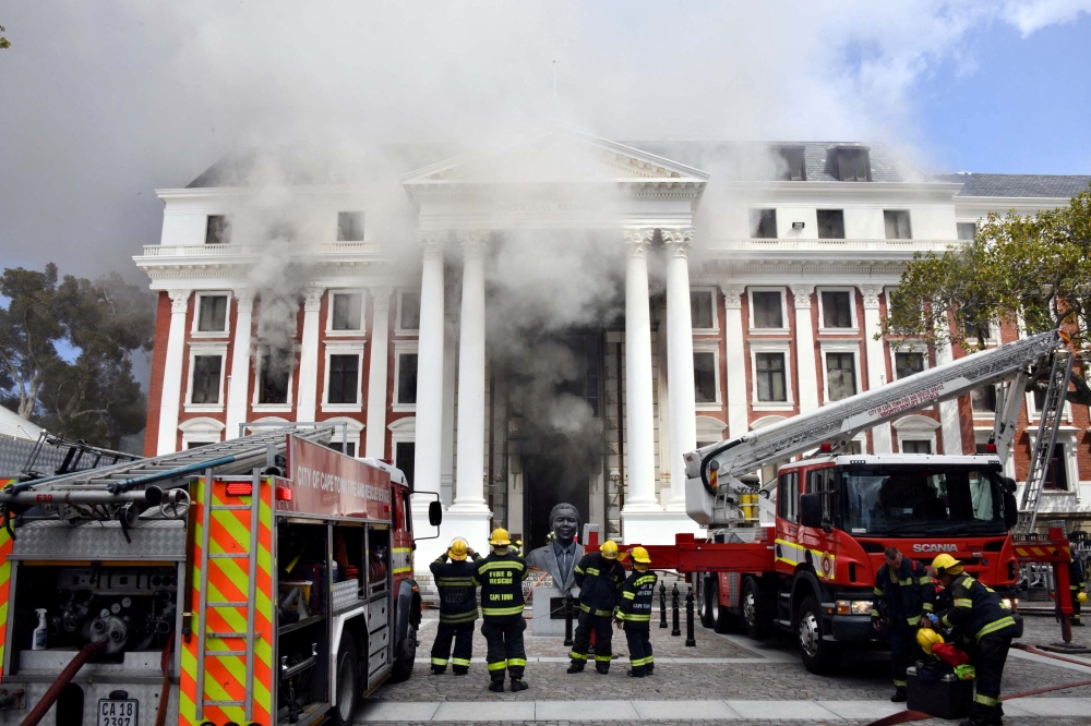 File photo: Firefighters work after a fire broke out in the Parliament in Cape Town, South Africa, January 2, 2022. Elmond Jiyane/GCIS/Handout via Reuters
