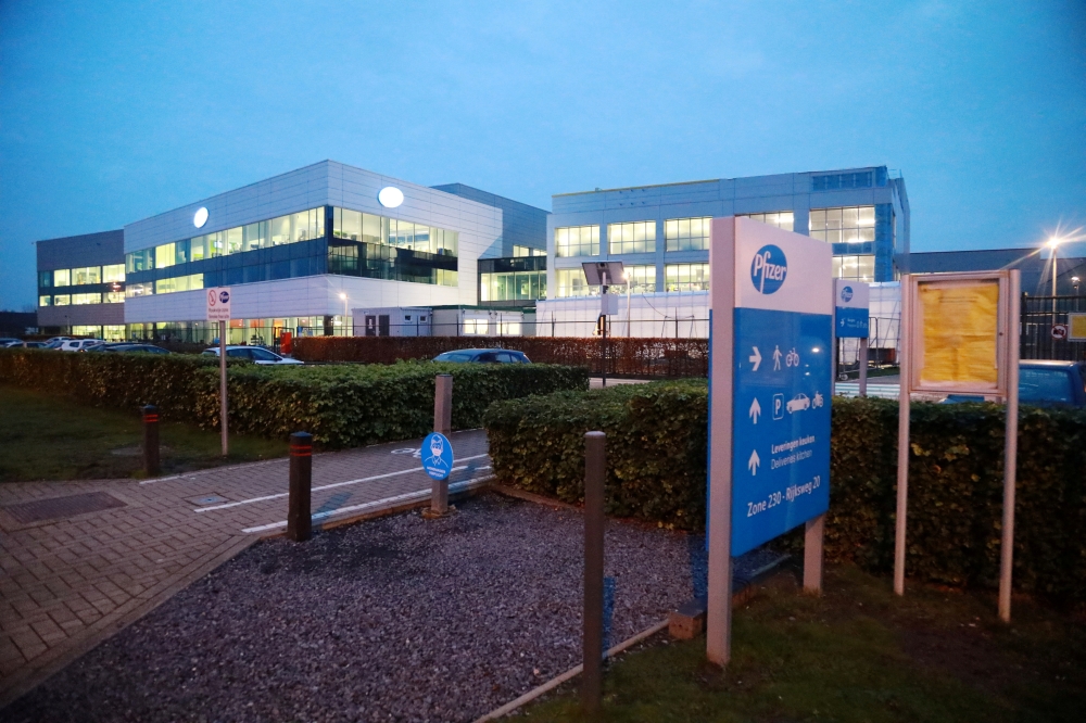 The Pfizer logo is seen at the entrance to Pfizer factory in Puurs, Belgium December 2, 2020. REUTERS/Bart Biesemans/File Photo