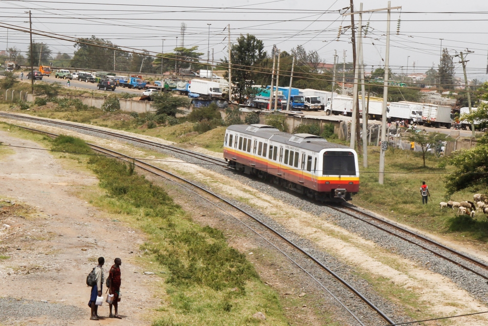 A Diesel Mobile Unit (DMU) train of the Nairobi Commuter Rail Service (NCRS) operated by the Kenya Railway Corporation (KRC) from Embakasi to Nairobi rides past electricity power lines near the Donholm station in Nairobi, Kenya January 11, 2022. REUTERS/Monicah Mwangi