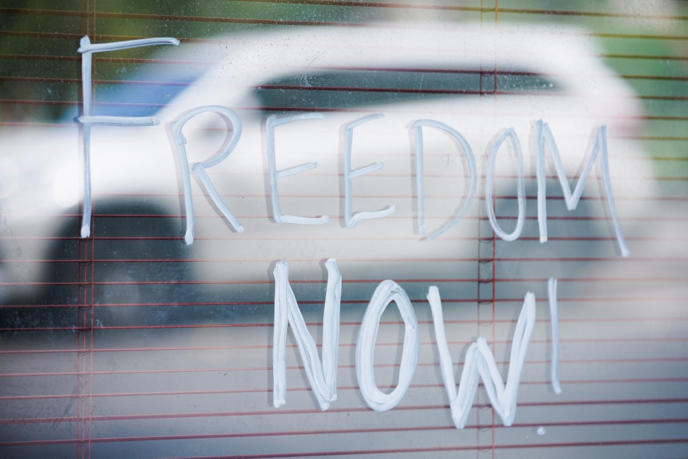 Freedom now!' graffiti is seen outside the Park Hotel, where Serbian tennis player Novak Djokovic later arrived for detention in federal custody, in Melbourne, Australia, January 15, 2022. Reuters/Sandra Sanders