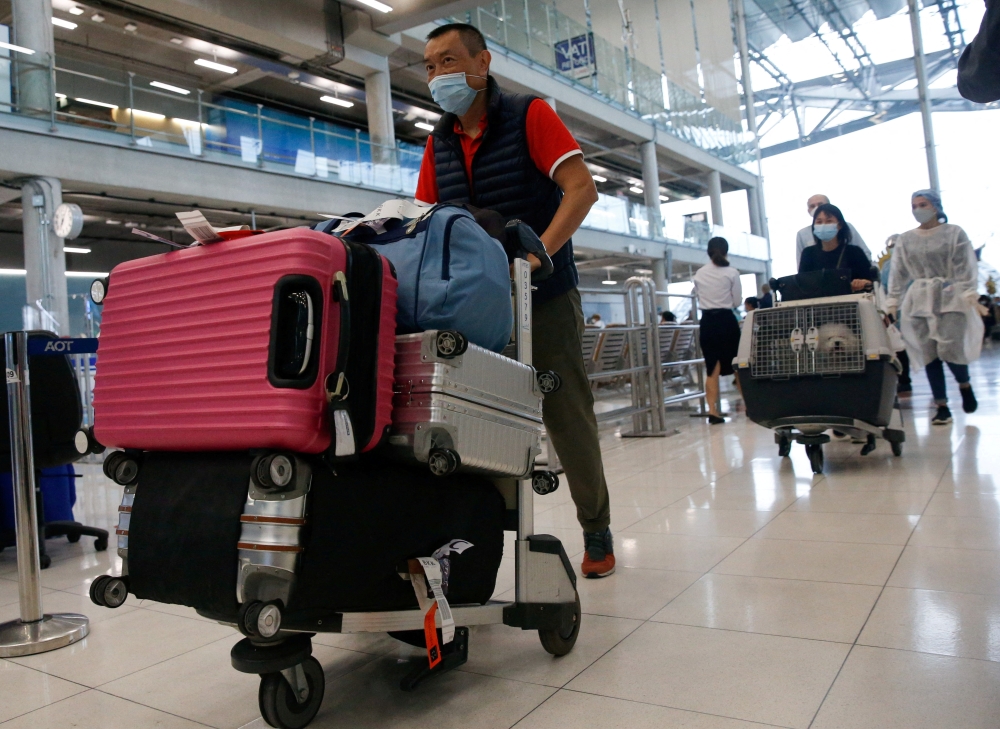 FILE PHOTO: First group of foreign tourists arrive at Suvarnabhumi Airport during the first day of the country's reopening campaign, part of the government's plan to jump start the pandemic-hit tourism sector in Bangkok, Thailand November 1, 2021. REUTERS/Soe Zeya Tun/