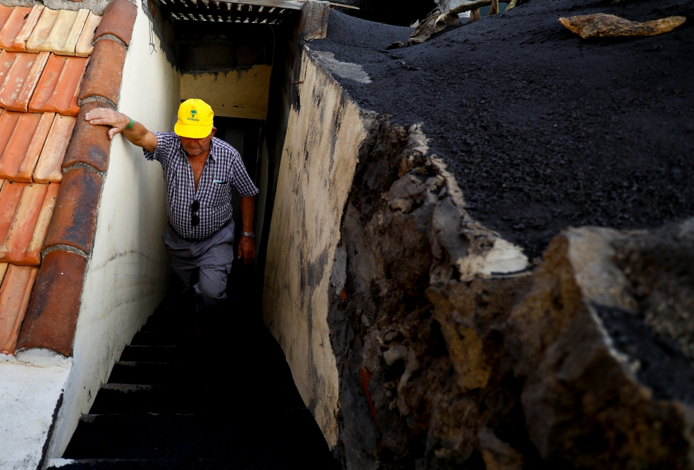 80-year-old Sabino Leal, a resident of Las Manchas, returns home for the first time since the eruption of the Cumbre Vieja volcano, on the Canary Island of La Palma, Spain, January 20, 2022. Picture taken January 20, 2022. REUTERS/Borja Suarez