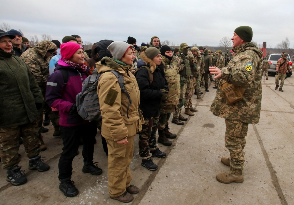 Reservists of the Ukrainian Territorial Defence Forces listen to instructions during military exercises at a training ground outside Kharkiv, Ukraine December 11, 2021. Reuters/Vyacheslav Madiyevskyy/File Photo