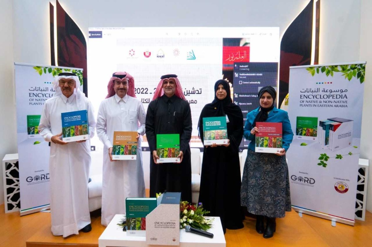 Officials showing copies of The Encyclopedia of Native & Non-Native Plants in Eastern Arabia during the launch ceremony at Doha International Book Fair.