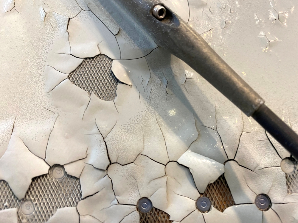 FILE PHOTO: An undated image shows what appears to be paint peeling, cracking and exposed expanded copper foil (ECF) on the fuselage of a Qatar Airways A350 aircraft grounded by the Qatari regulator. Image obtained by Reuters
