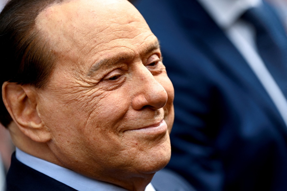 FILE PHOTO: Italy's former prime minister, Silvio Berlusconi, reacts after casting his vote during Italian elections for mayors and councillors, in Milan, Italy, October 3, 2021. REUTERS/Flavio Lo Scalzo/File Photo
