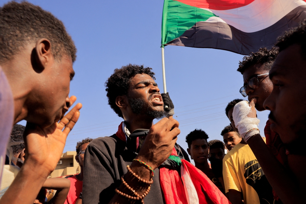 People attend a march during a protest against military rule following last month's coup in Khartoum, Sudan, January 24, 2022. REUTERS.
