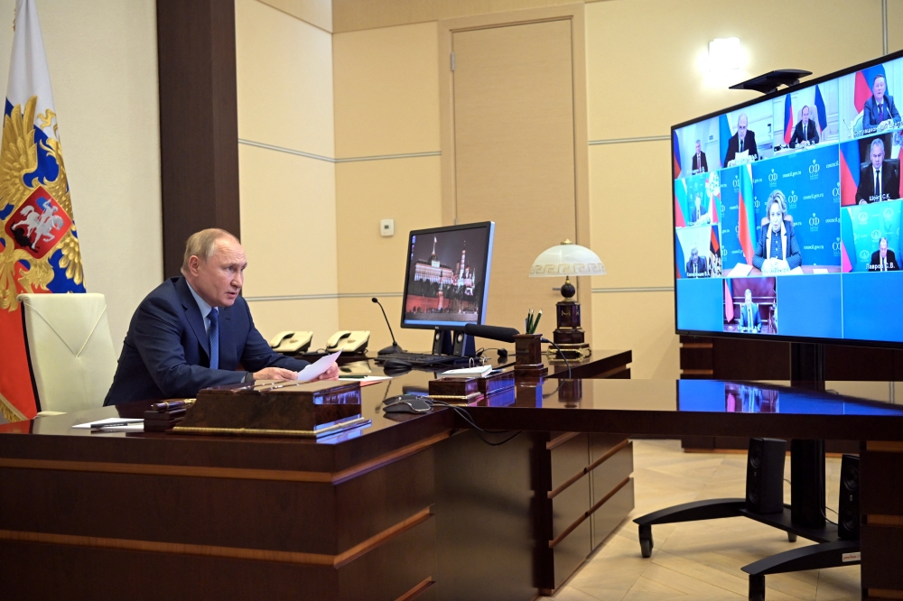 Russian President Vladimir Putin chairs a meeting with members of the Security Council via a video link at the Novo-Ogaryovo state residence outside Moscow, Russia January 28, 2022.