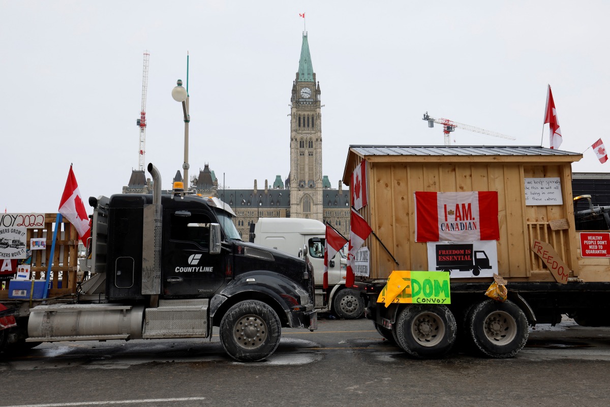 Vehicles displaying protest signs are seen outside Parliament Hill, as demonstrations by truckers and their supporters against the coronavirus disease (COVID-19) vaccine mandates continue, in Ottawa, Ontario, Canada, January 31, 2022. REUTERS/Blair Gable
