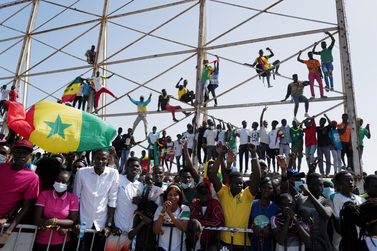 Senegalese fans celebrate as they wait to welcome the Senegal National Soccer Team after their Africa Cup win, in Dakar, Senegal February 7, 2022. REUTERS/ Zohra Bensemra
