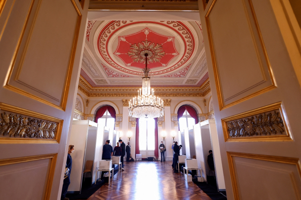 People stand in the hall as vaccinations against the coronavirus disease (COVID-19) take place at the Bavarian State Opera House in Munich, Germany, February 10, 2022. REUTERS/Michaela Rehle/File Photo