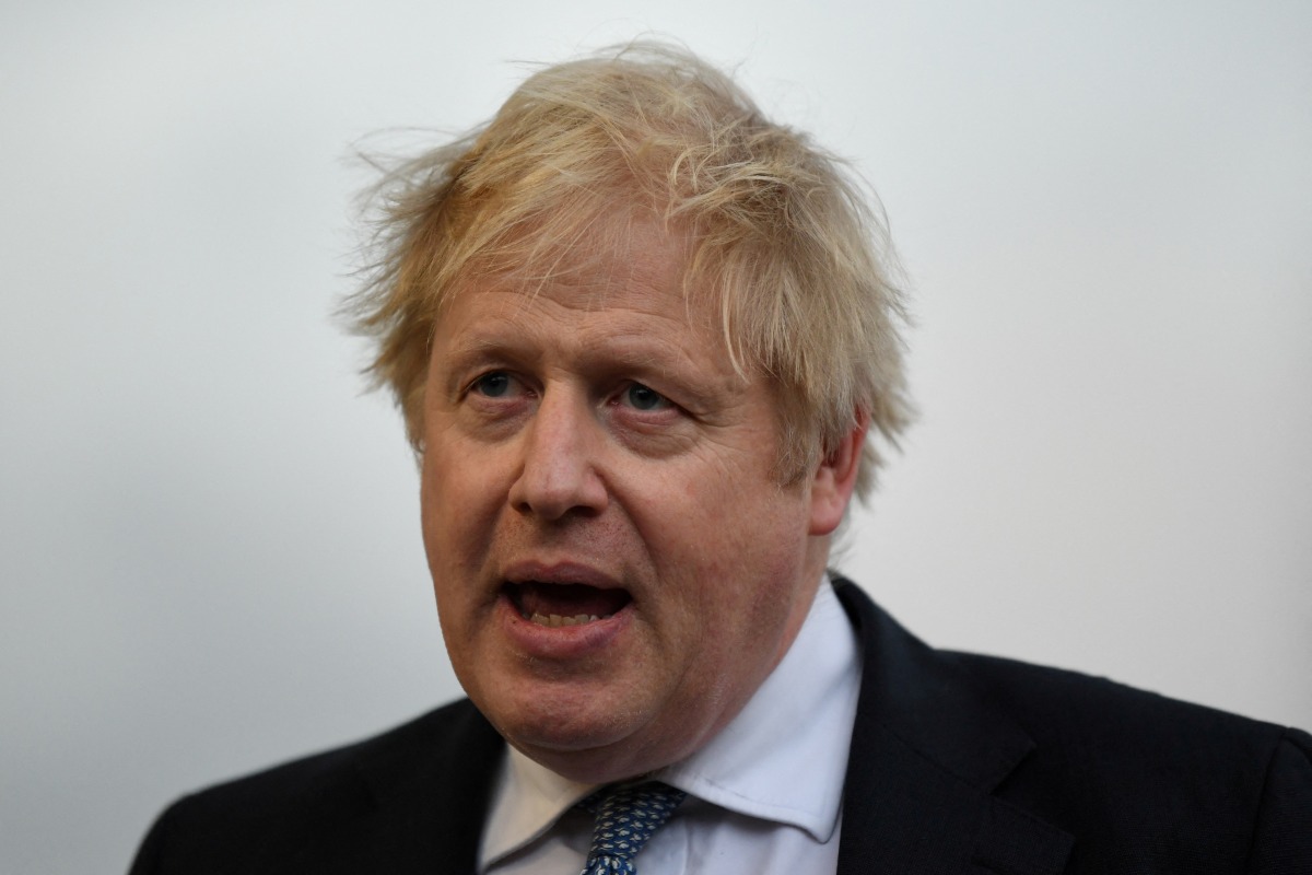 FILE PHOTO: Britain's Prime Minister Boris Johnson speaks with members of the media during a visit to Warszawska Brygada Pancerna military base near Warsaw, Poland February 10, 2022. Daniel Leal/Pool via REUTERS/File Photo
