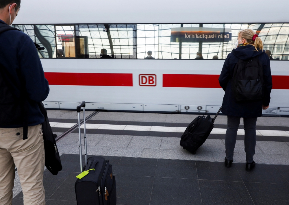 People wait for a train to arrive at the DB Berlin Hauptbahnhof or Berlin main train station in Berlin, Germany September 2, 2021. REUTERS/Michele Tantussi/File Photo