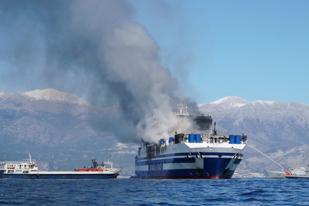 Smoke rises from the burning Italian-flagged Euroferry Olympia, after a fire broke out on the ferry, off the island of Corfu, Greece, February 18, 2022. REUTERS/Adonis Skordilis