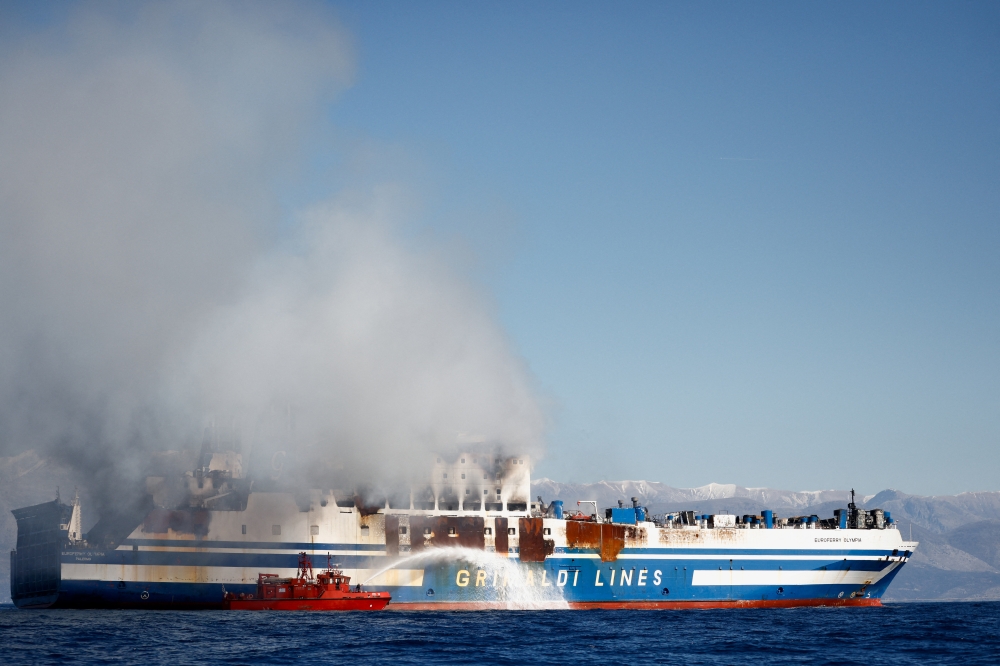 Smoke rises from the Italian-flagged Euroferry Olympia, which sailed from Greece to Italy early on Friday and caught fire, off the coast of Corfu, Greece, February 19, 2022. Reuters/Guglielmo Mangiapane