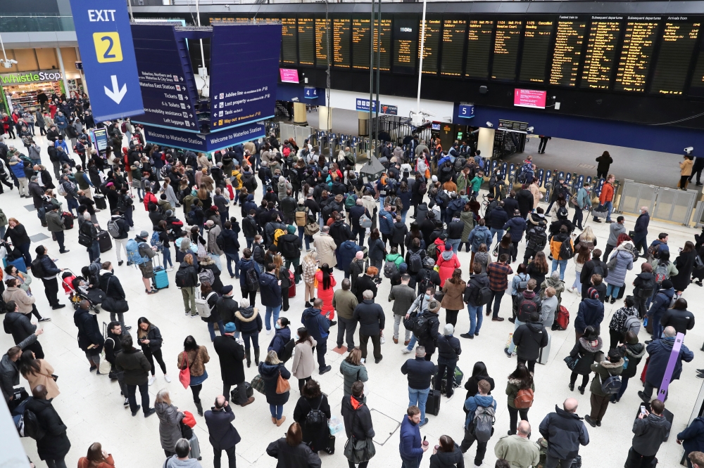 People wait at Waterloo station, as trains are delayed and cancelled after Storm Eunice, in London, Britain, February 19, 2022. REUTERS/May James