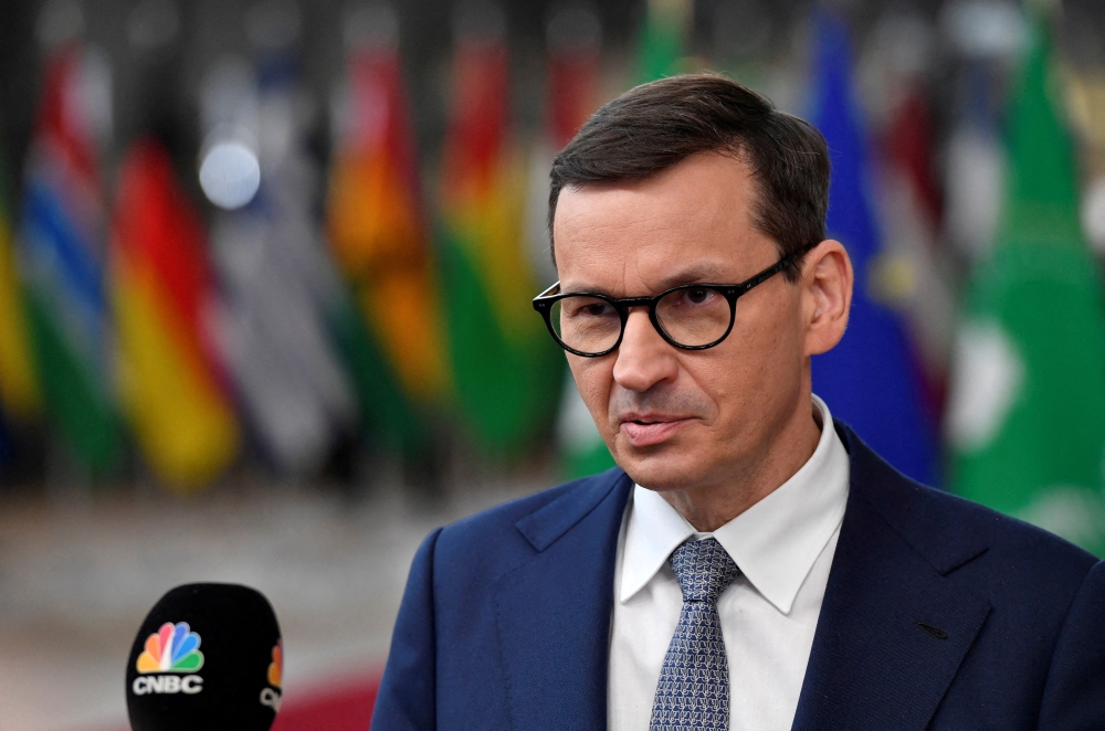 Poland’s Prime Minister Mateusz Morawiecki speaks with the media as he arrives for the EU-Africa summit at the European Council building in Brussels, Belgium February 17, 2022. Geert Vanden Wijngaert/Pool via REUTERS/File Photo