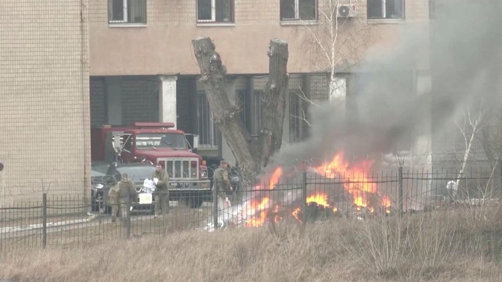 Uniformed people are seen throwing items into a fire outside intelligence building on the premises of the Ukrainian Defence Ministry's unit, in Kyiv, Ukraine February 24, 2022 in this screen grab taken from a video. REUTERS 