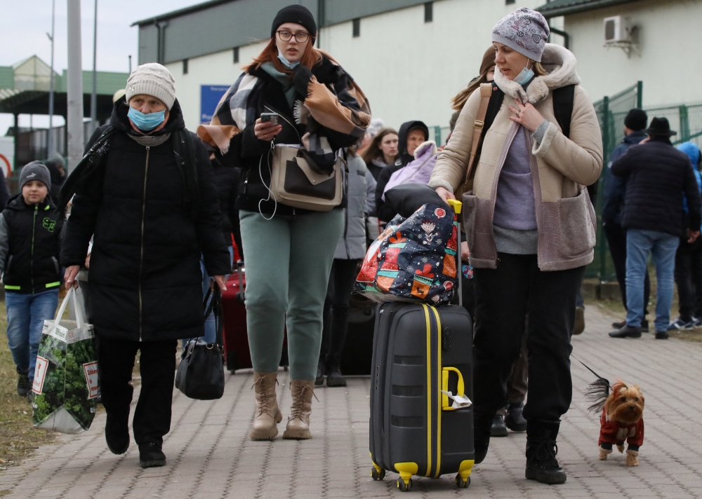 People arrive at the border crossing between Poland and Ukraine, after Russia launched a massive military operation against Ukraine, in Medyka, Poland, February 25, 2022. REUTERS/Kacper Pempel