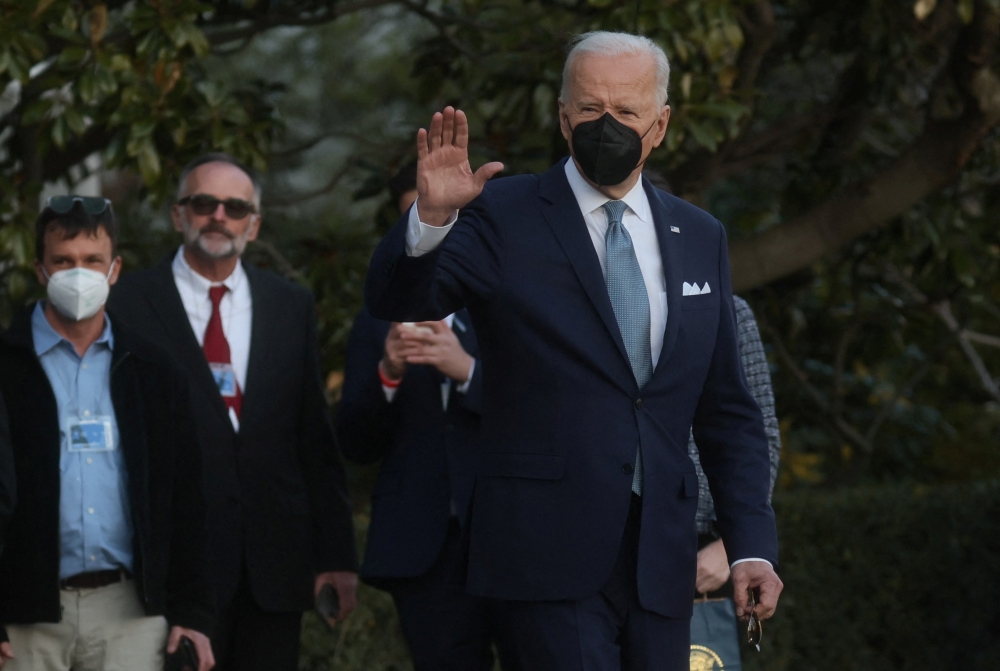 U.S. President Joe Biden waves to the media before boarding Marine One for travel to Delaware from the South Lawn of the White House in Washington, U.S., February 25, 2022. REUTERS/Leah Millis