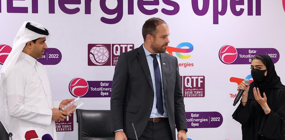 Qatari artist Noof Al Naimi speaking to Nasser Al Khelaifi (left), President of the Qatar Tennis, Squash and Badminton Federation, and Matthieu Bouyer (centre), Managing Director TotalEnergies EP Qatar and Country Chair.