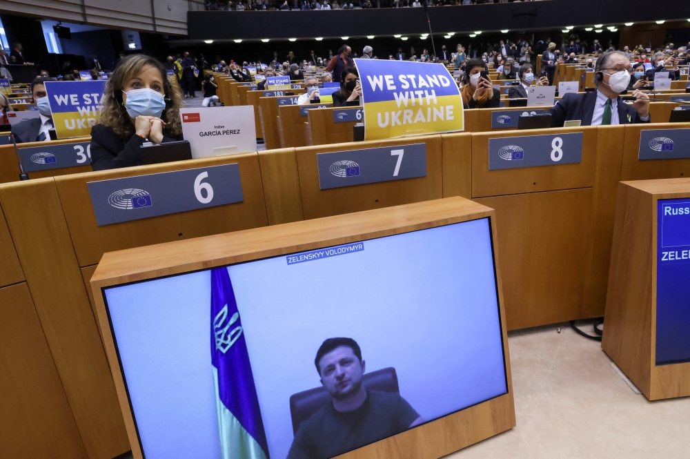 Ukrainian President Volodymyr Zelenskiy addresses the European Parliament special session, from a screen, to debate its response to the Russian invasion of Ukraine, in Brussels, Belgium March 1, 2022. Reuters/Yves Herman