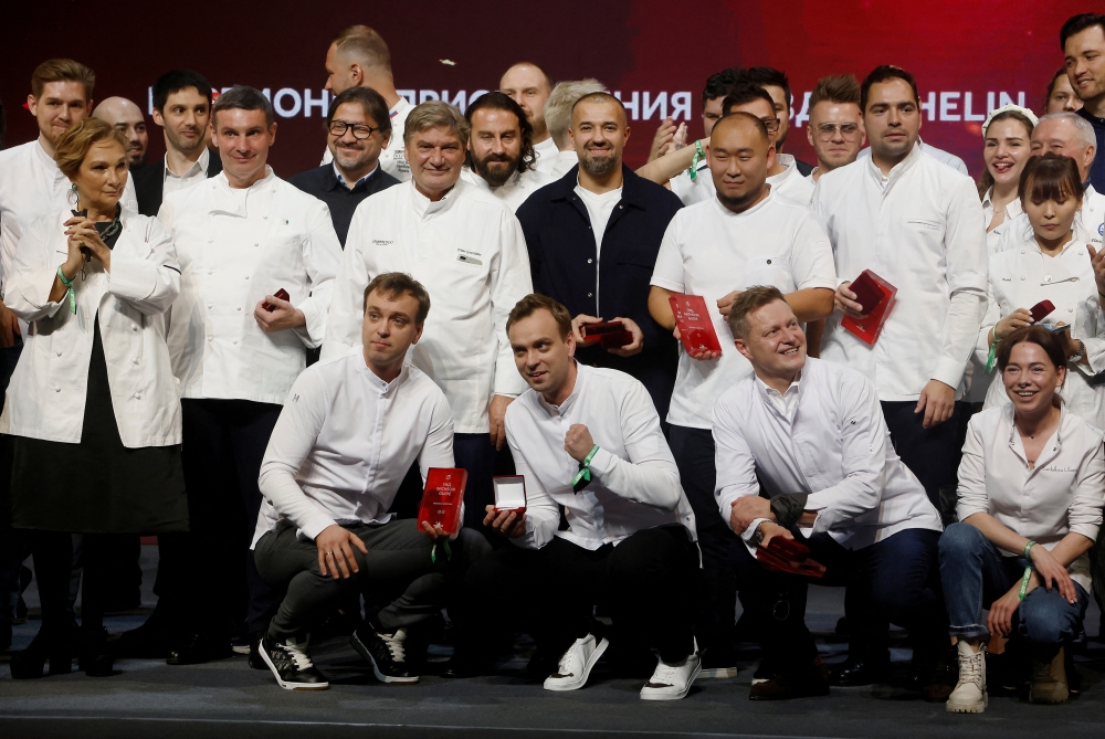 Chefs celebrate on stage during the Michelin Guide 2022 award ceremony in Moscow, Russia October 14, 2021. REUTERS/Maxim Shemetov/File Photo