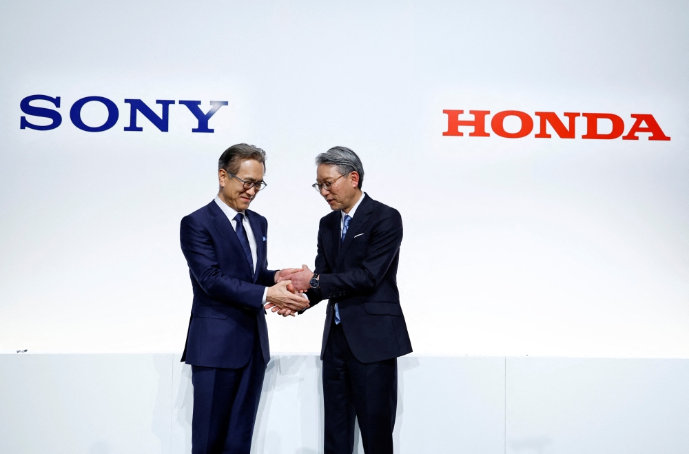 Sony Corp's Chief Executive Kenichiro Yoshida shakes hands with Honda Motor's Toshihiro Mibe attend a joint news conference at Sony's headquarters in Tokyo, Japan, March 4, 2022. REUTERS/Kim Kyung-Hoon