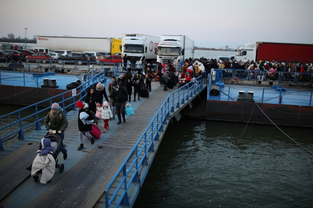People arrive by ferry after fleeing from Russia's invasion of Ukraine, at the Isaccea-Orlivka border crossing, Romania, March 5, 2022. Reuters/Stoyan Nenov