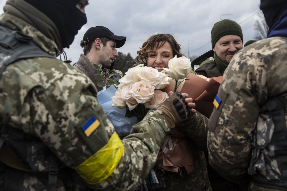Members of the Territorial Defense Forces give roses to Filimonova. Photo by Heidi Levine for The Washington Post.