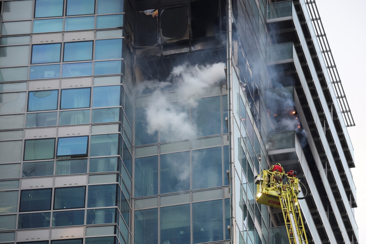 Firefighters extinguish a fire at a building in East London, Britain, March 7, 2022. REUTERS/Phil Noble
