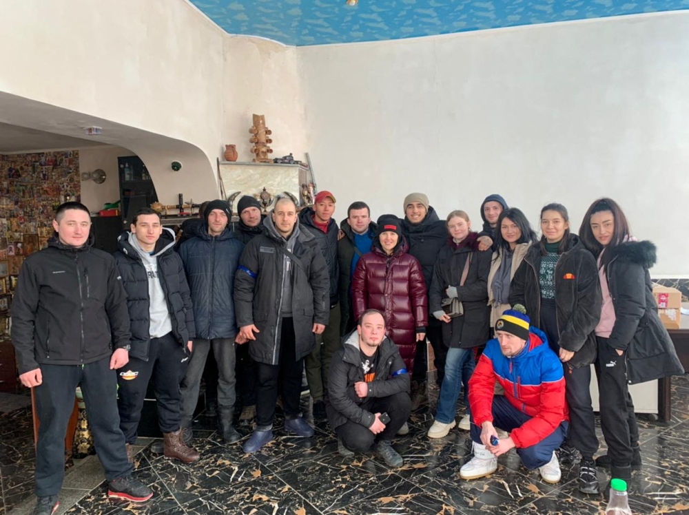 Local resident Teimur Aliev poses with his team of volunteers that deliver food and aid, amid the Russian invasion, in Kharkiv, Ukraine in this undated handout image obtained March 12, 2022. Teimur Aliev/Handout via REUTERS