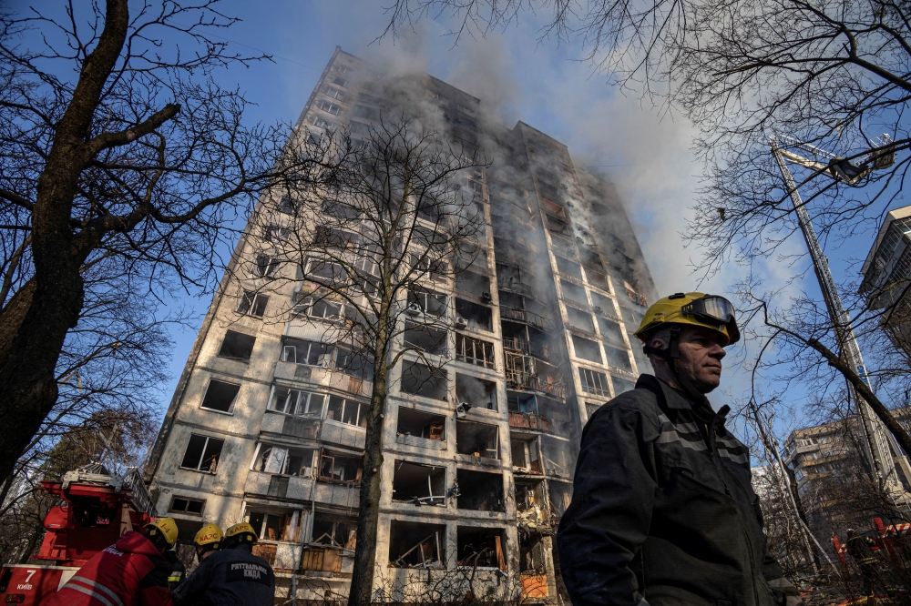 Firefighters work to put out a fire in a residential apartment building after it was hit by shelling as Russia's invasion of Ukraine continues, in Kyiv, Ukraine, March 15, 2022. REUTERS/Marko Djurica