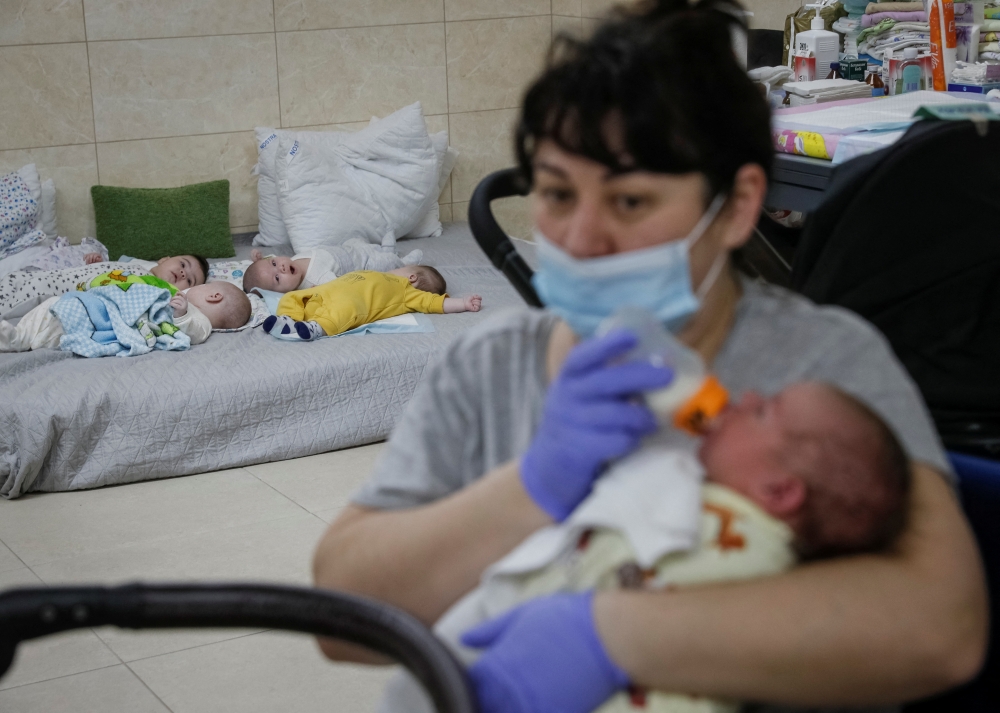Nurse Oksana Martynenko looks after surrogate-born babies inside a special shelter owned by BioTexCom clinic in a residential basement, as Russia's invasion continues, on the outskirts of Kyiv, Ukraine March 15, 2022. Reuters/Gleb Garanich