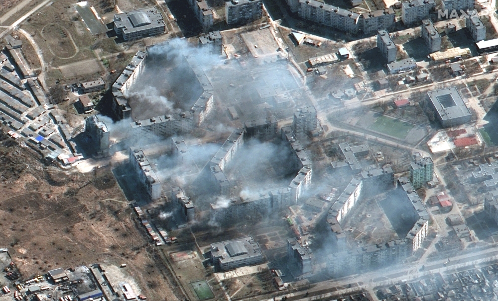 A satellite image shows burning apartment buildings in Mariupol, Ukraine, March 19, 2022. Satellite image ©2022 Maxar Technologies