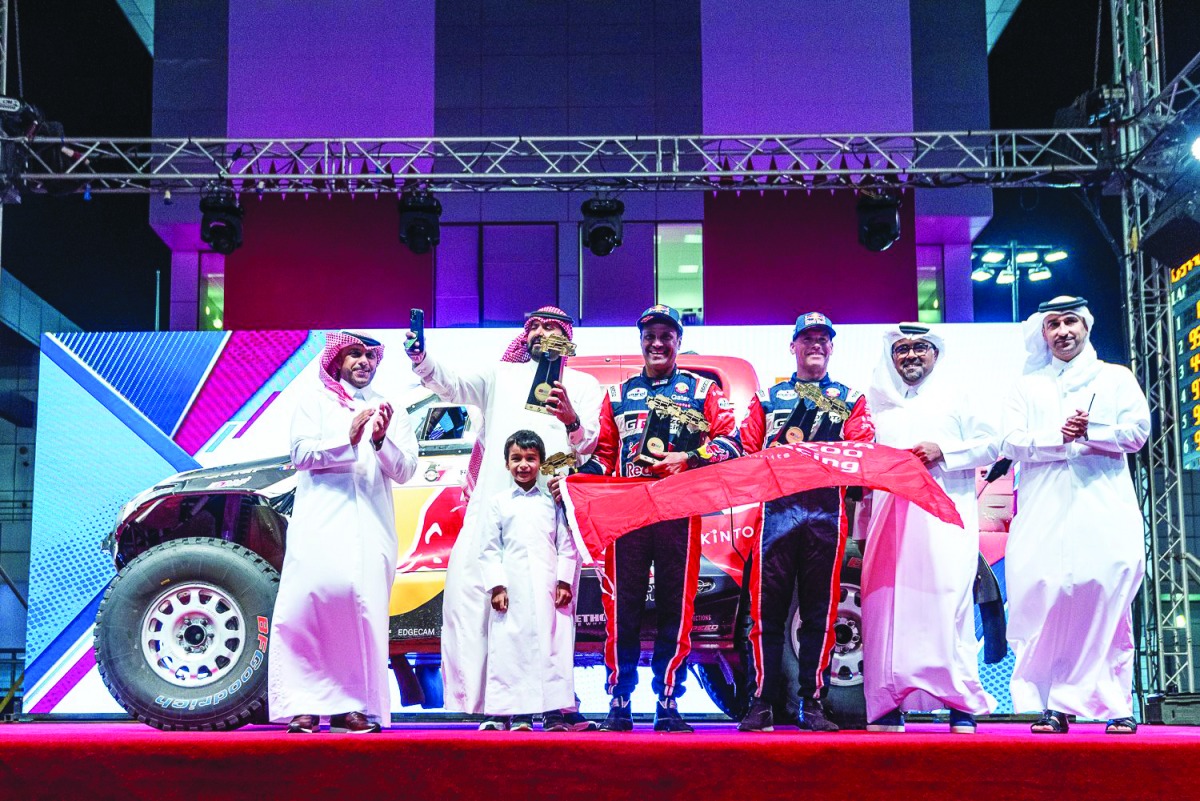 Qatar Motor and Motorcycle Federation (QMMF) President Abdul Rahman bin Abdul Latif Al Mannai with QMMF's Executive Director Amro Al Hamad, champions Nasser Saleh Al Attiyah Al Attiyah and French co-driver Mathieu Baumel along with other officials during the presentation ceremony, yesterday. 